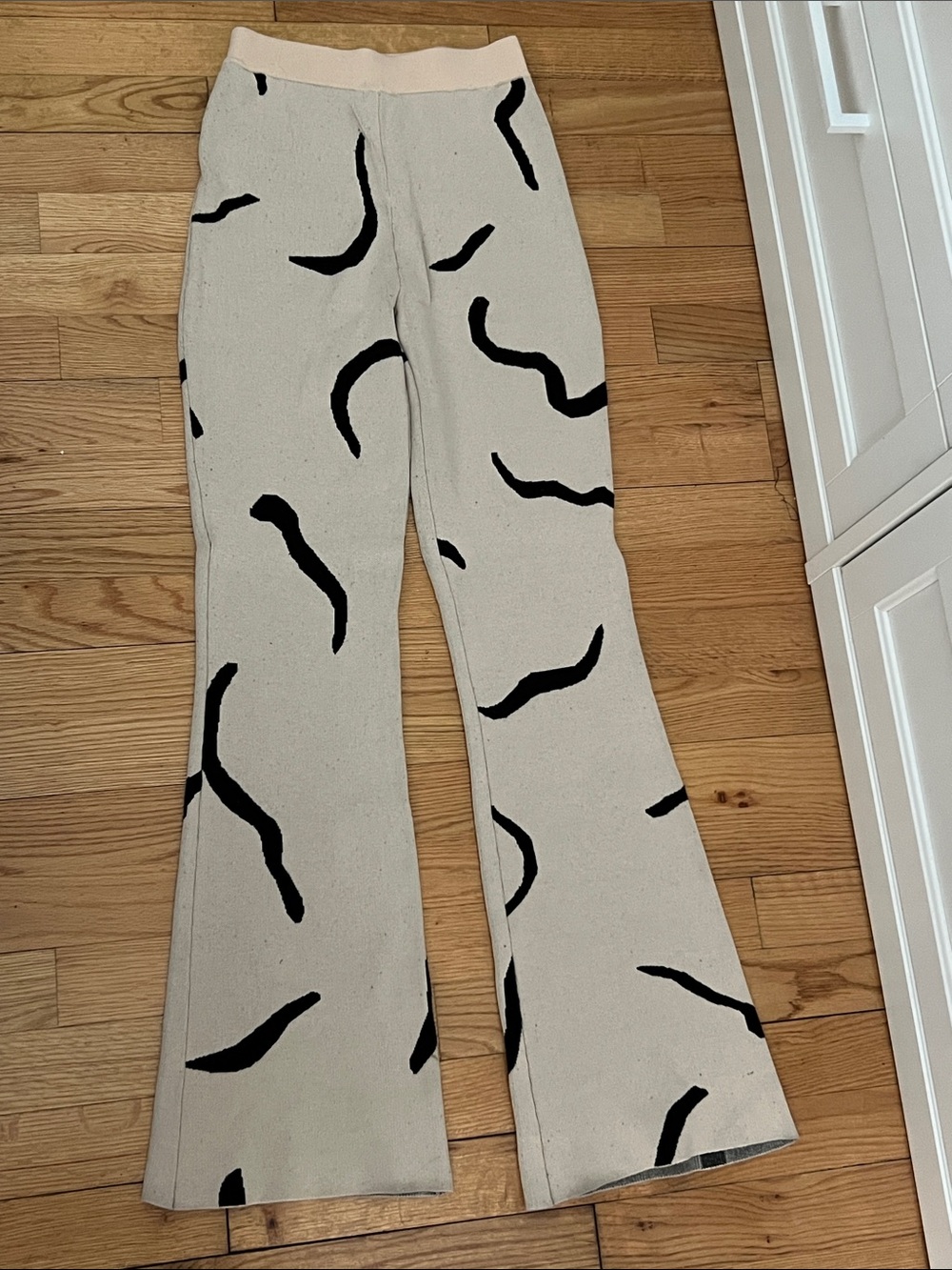 White Fox Boutique Cream Boot‑Cut Pants with Black Abstract Motif
